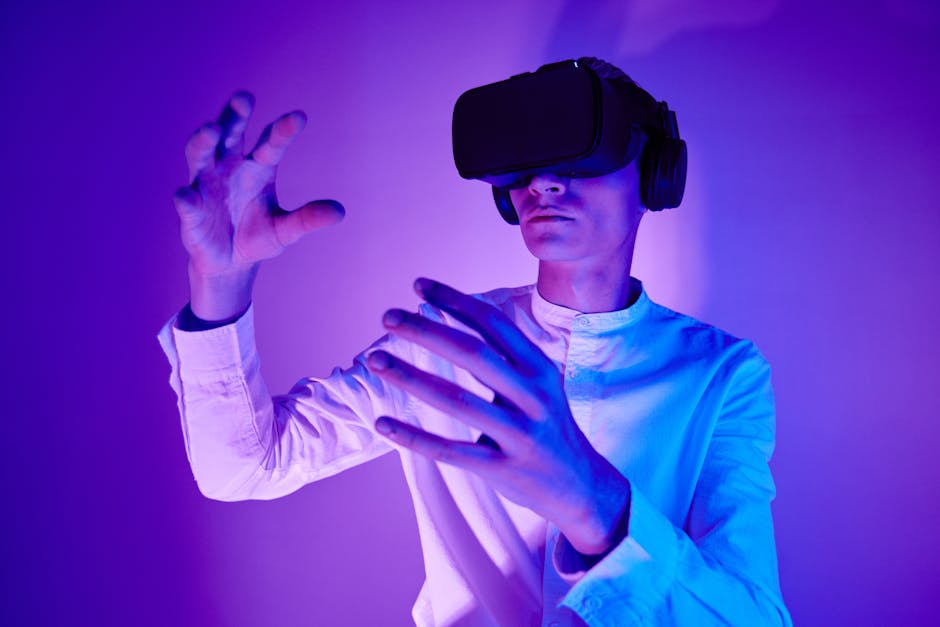 A man wearing VR goggles interacts with a virtual environment in a studio shot with vibrant lighting